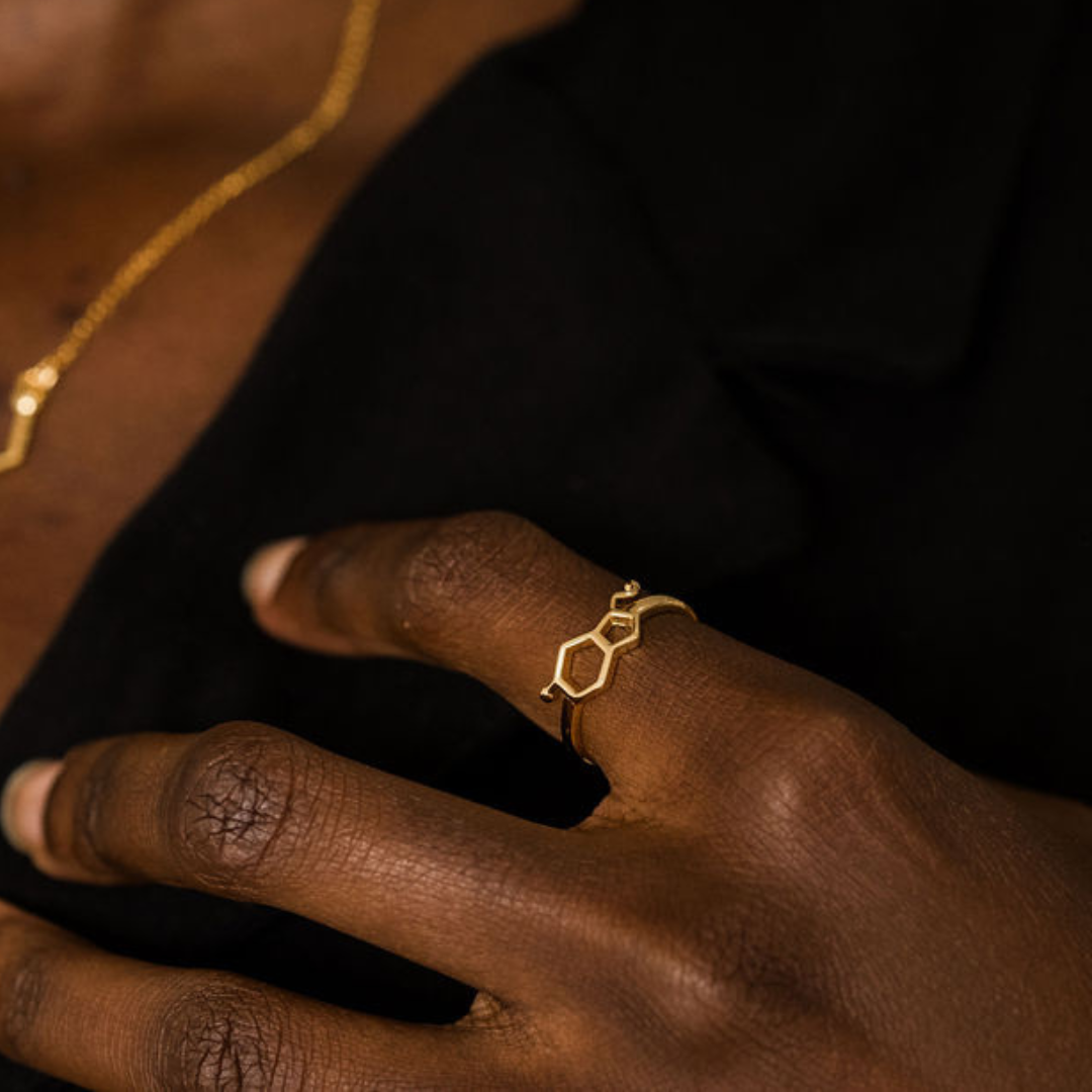 Model wearing serotonin molecule ring in gold - chemistry inspired jewellery for science lovers | My Chemical Gift