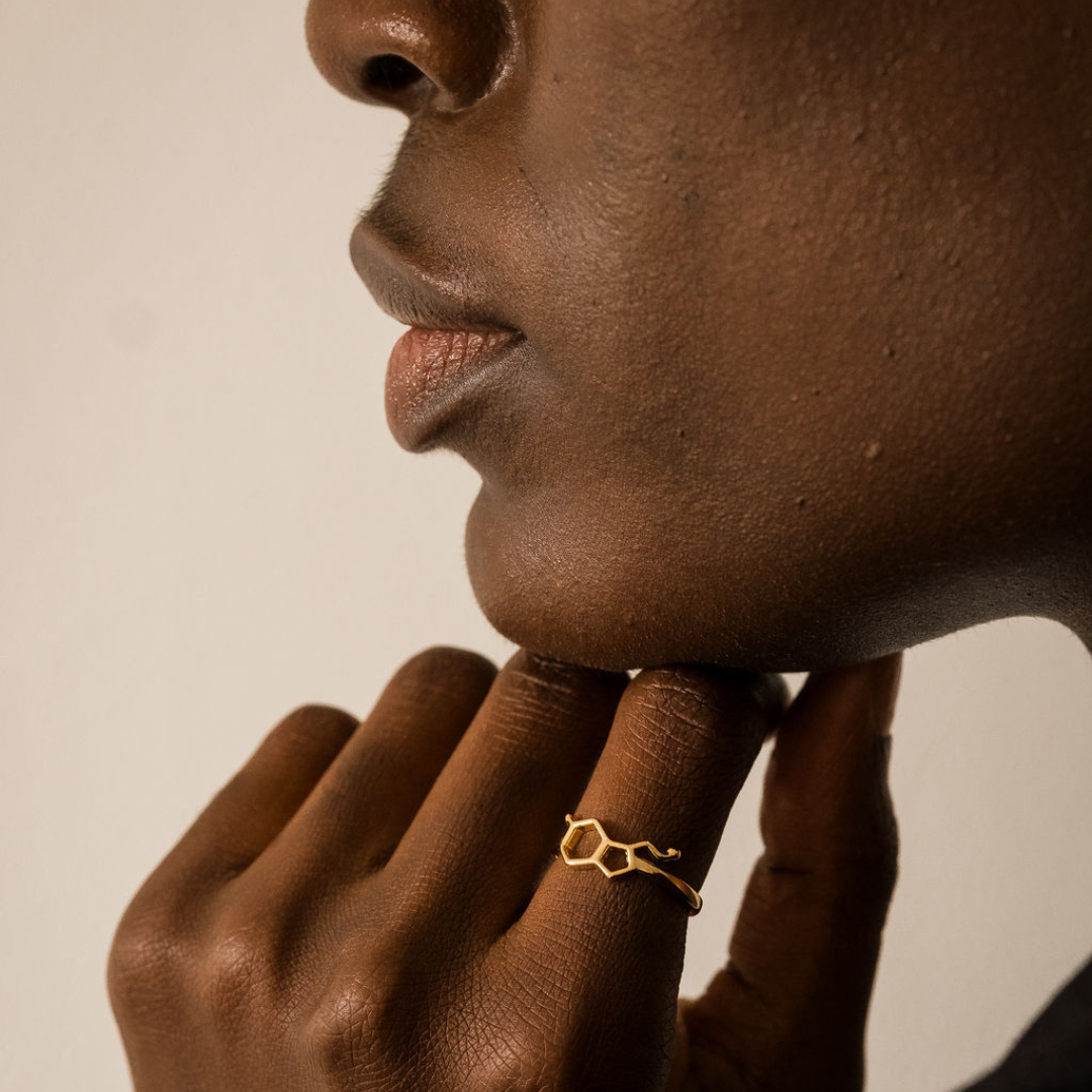 Model wearing serotonin molecule ring in gold - chemistry inspired jewellery for science lovers | My Chemical Gift
