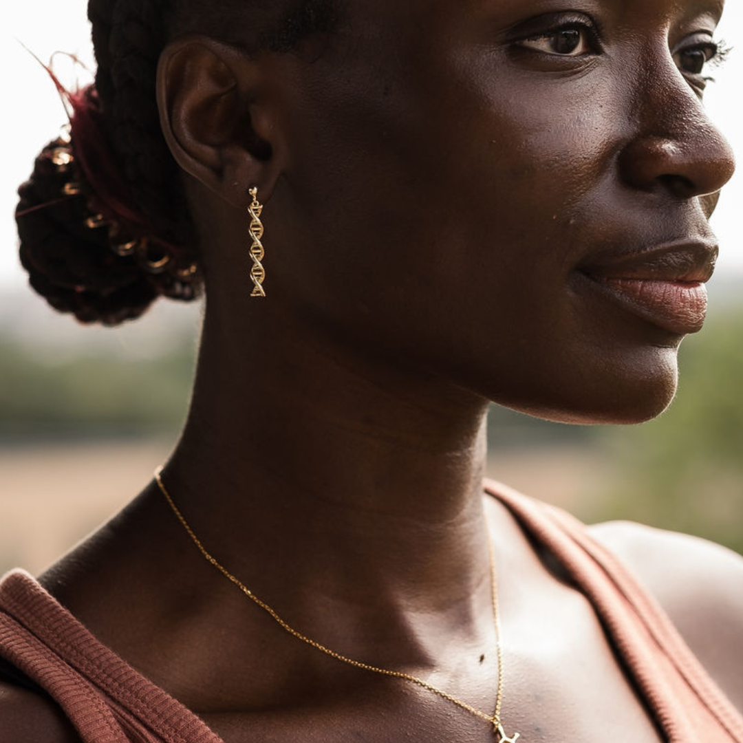Model wearing DNA double helix earrings in gold - chemistry inspired jewellery gift for science lovers | My Chemical Gift