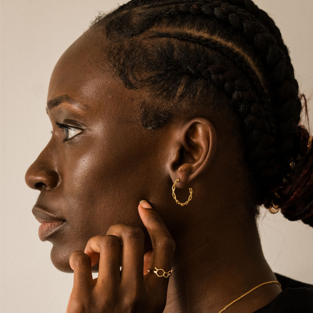 Model wearing DNA double helix hoop earrings in gold - chemistry inspired jewellery for science lovers | My Chemical Gift