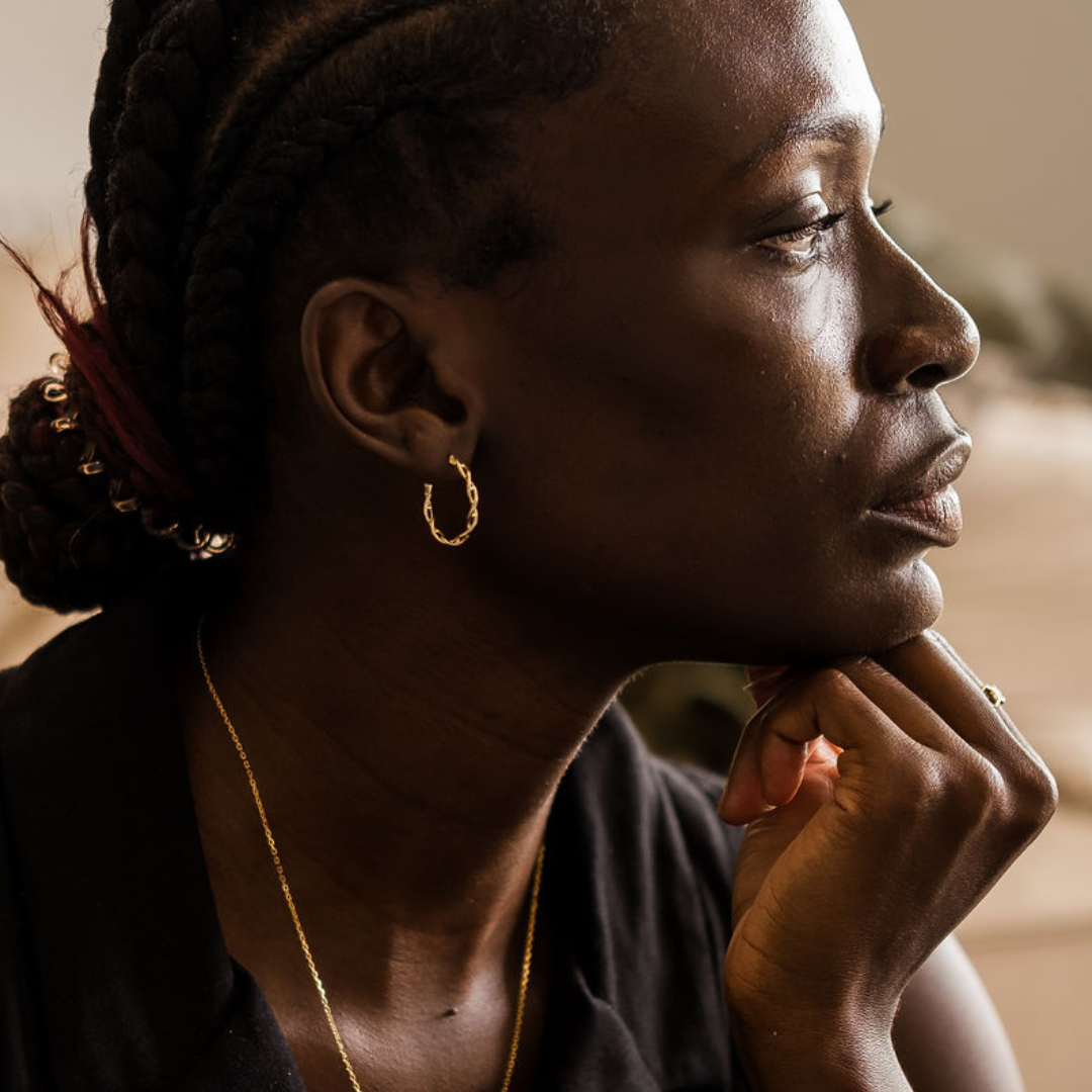 Model wearing DNA double helix hoop earrings in gold - chemistry inspired jewellery for science lovers | My Chemical Gift