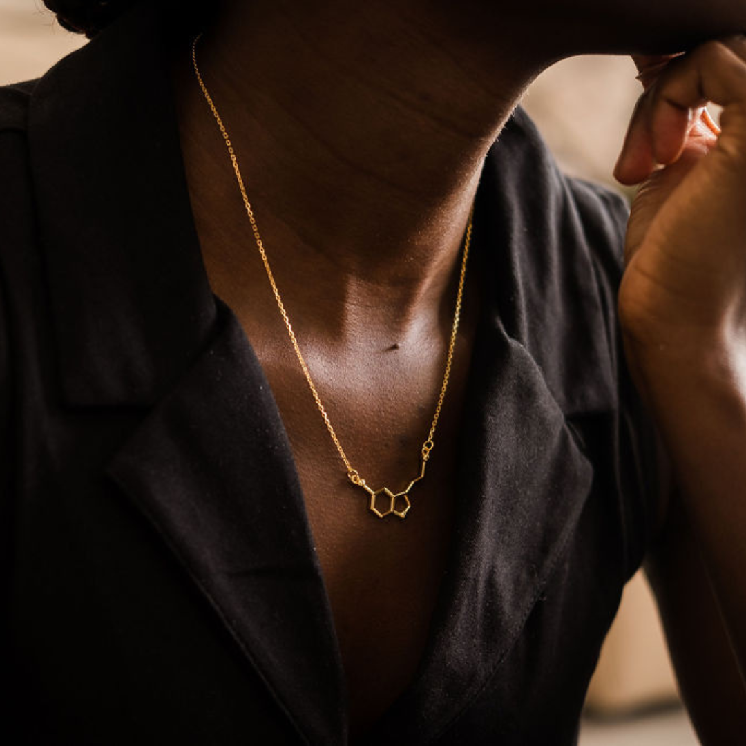 Model wearing serotonin molecule necklace in gold - chemistry inspired jewellery for science lovers | My Chemical Gift