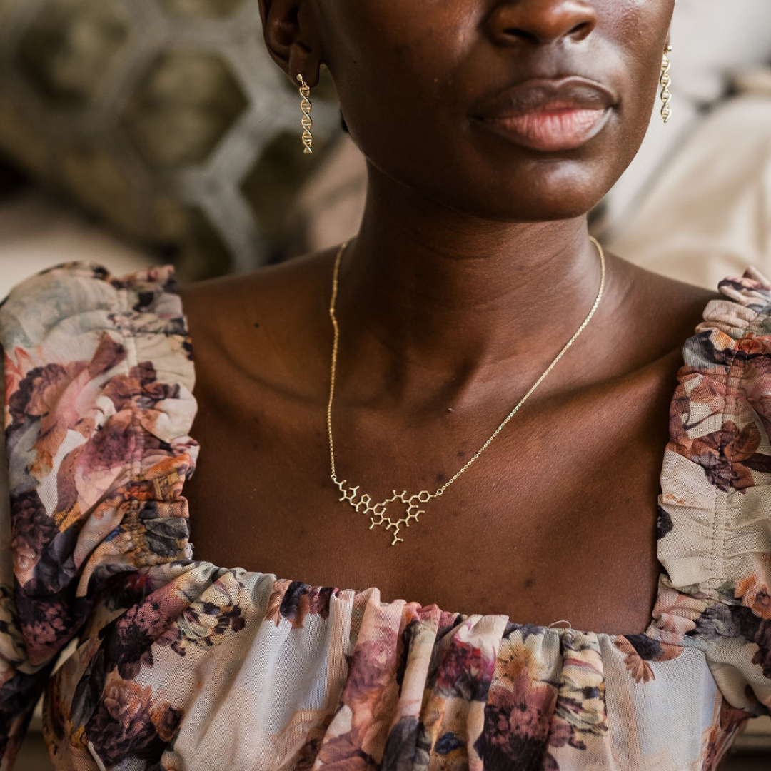 Model wearing oxytocin molecule necklace in gold - love hormone pendant | My Chemical Gift