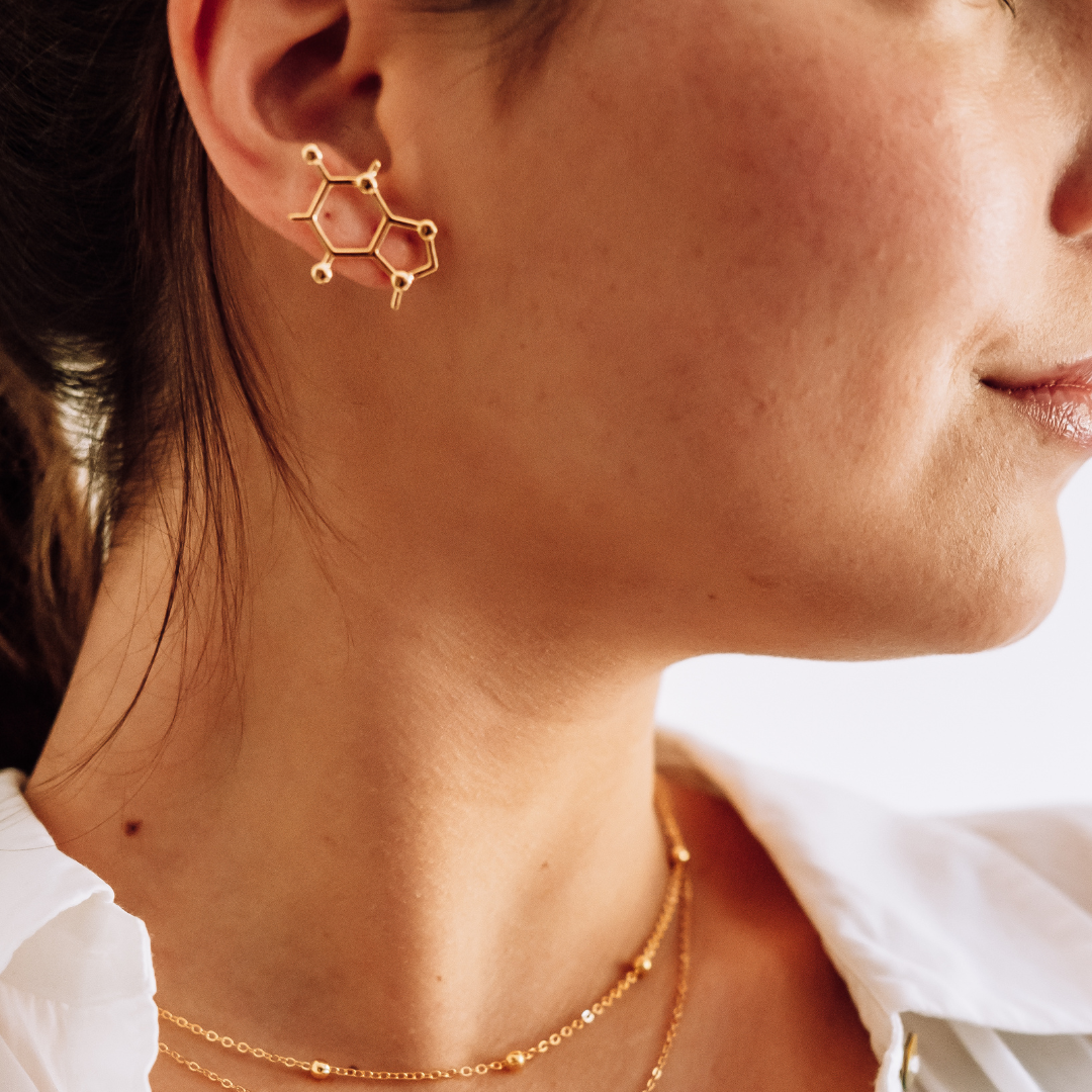 Model wearing caffeine molecule earrings in gold - science inspired jewellery gift for coffee lovers | My Chemical Gift