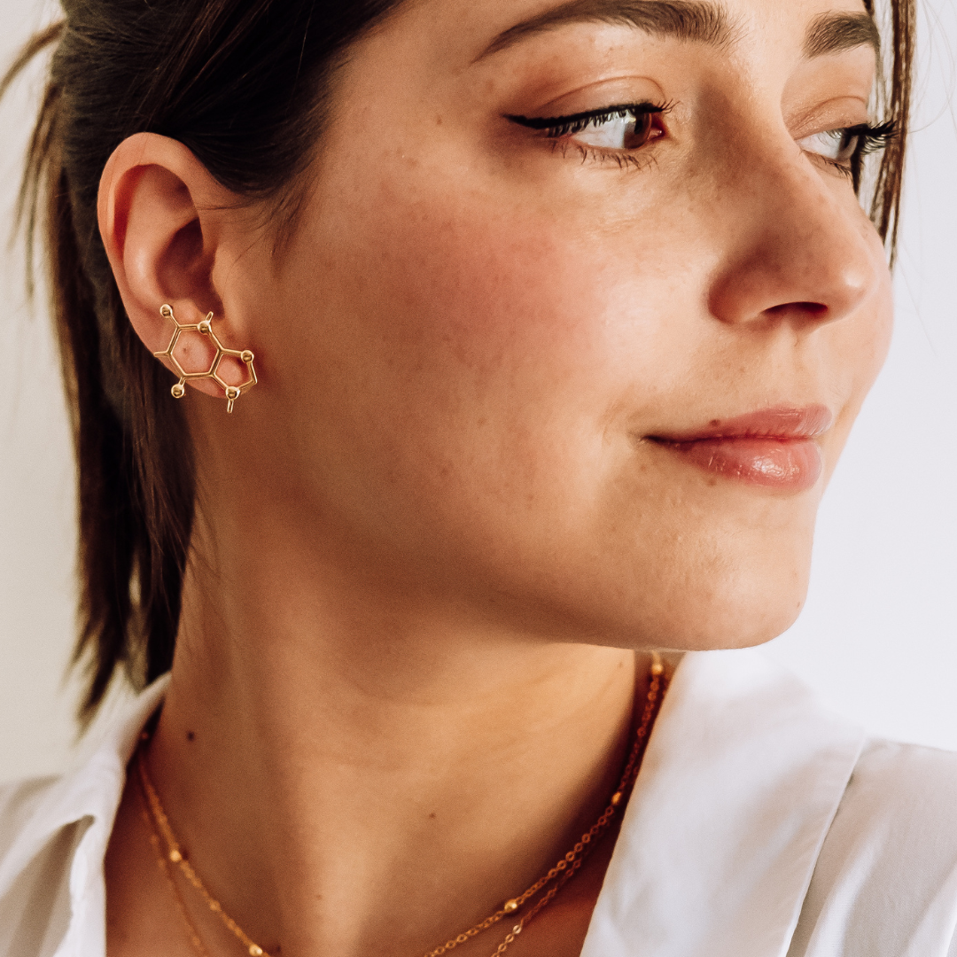 Model wearing caffeine molecule earrings in gold - science inspired jewellery for coffee lovers | My Chemical Gift