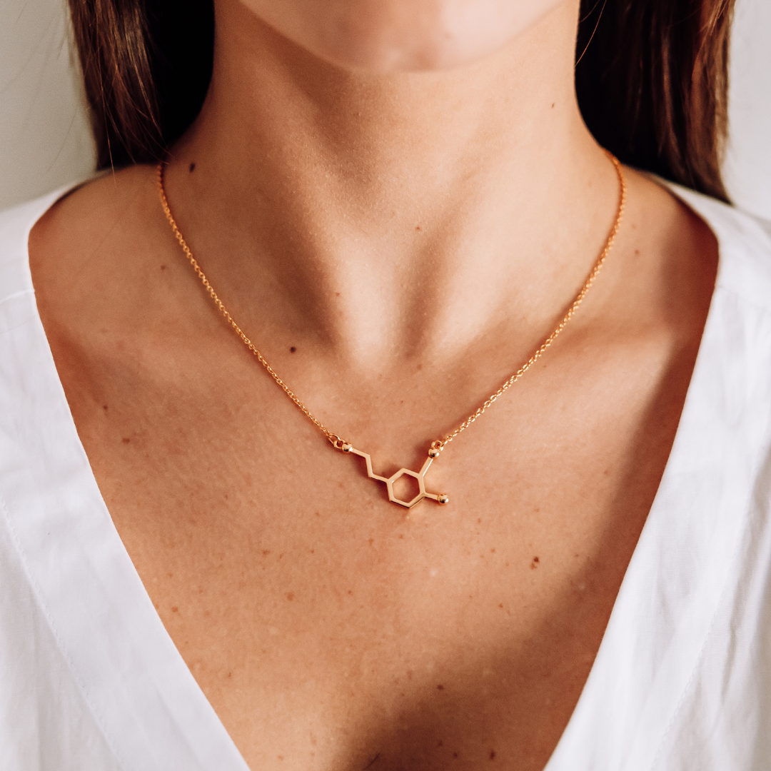 Model wearing dopamine molecule necklace in gold - chemistry inspired jewellery for science lovers | My Chemical Gift