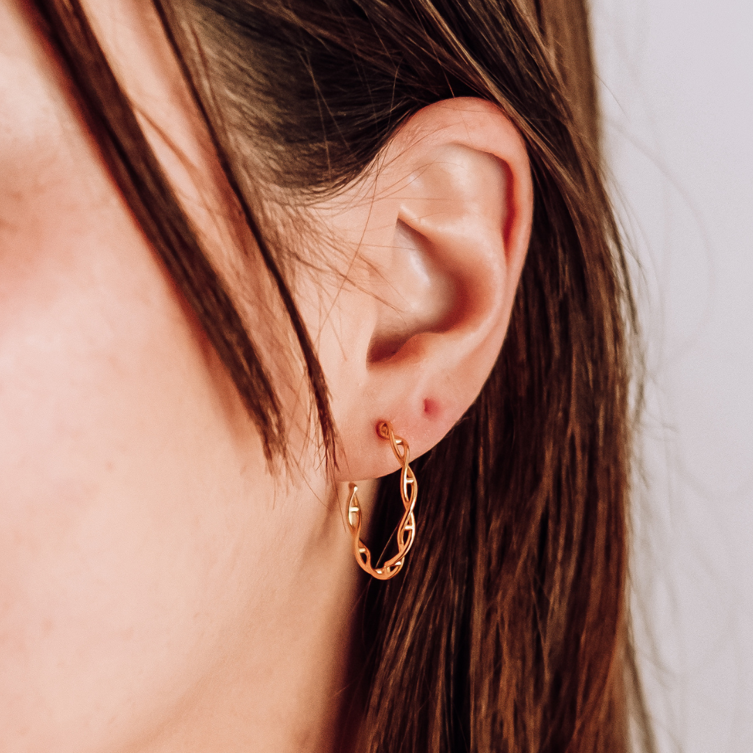 Model wearing DNA double helix hoop earrings in gold - chemistry inspired jewellery for science lovers | My Chemical Gift