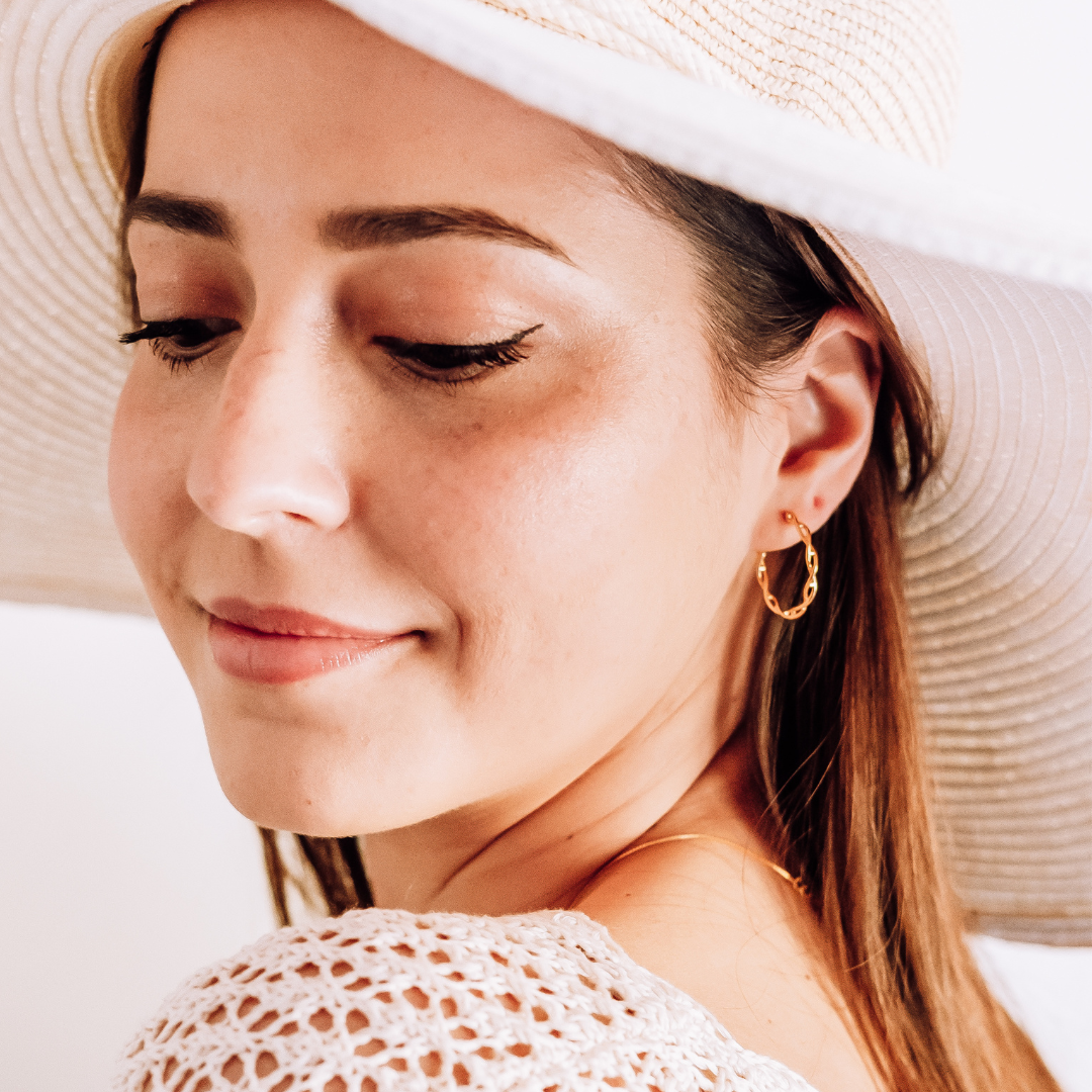 Model wearing DNA double helix hoop earrings in gold - chemistry inspired jewellery for science lovers | My Chemical Gift