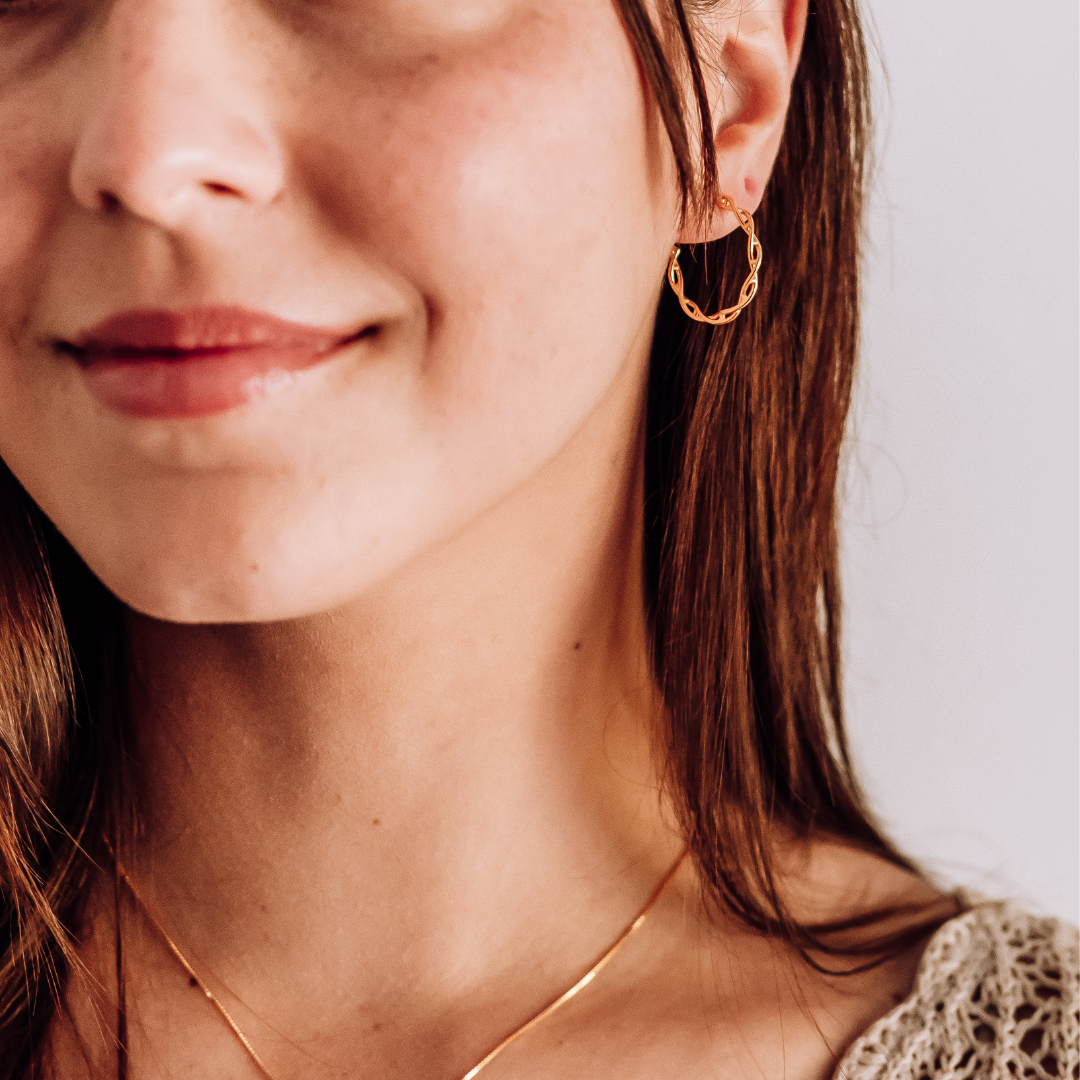 Model wearing DNA double helix hoop earrings in gold - chemistry inspired jewellery for science lovers | My Chemical Gift