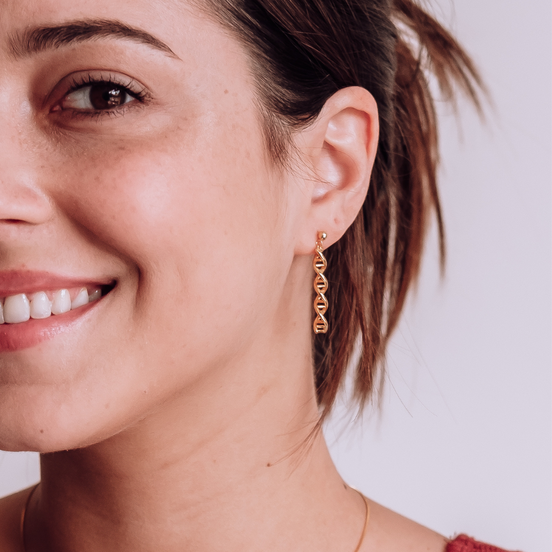 Model wearing DNA double helix earrings in gold - chemistry inspired jewellery gift for science lovers | My Chemical Gift