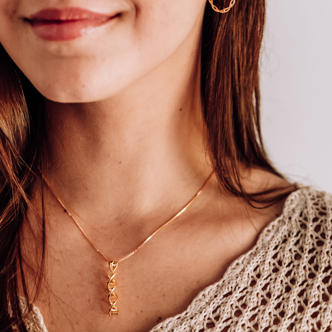 Model wearing DNA double helix necklace in gold - chemistry inspired jewellery gift for science lovers | My Chemical Gift