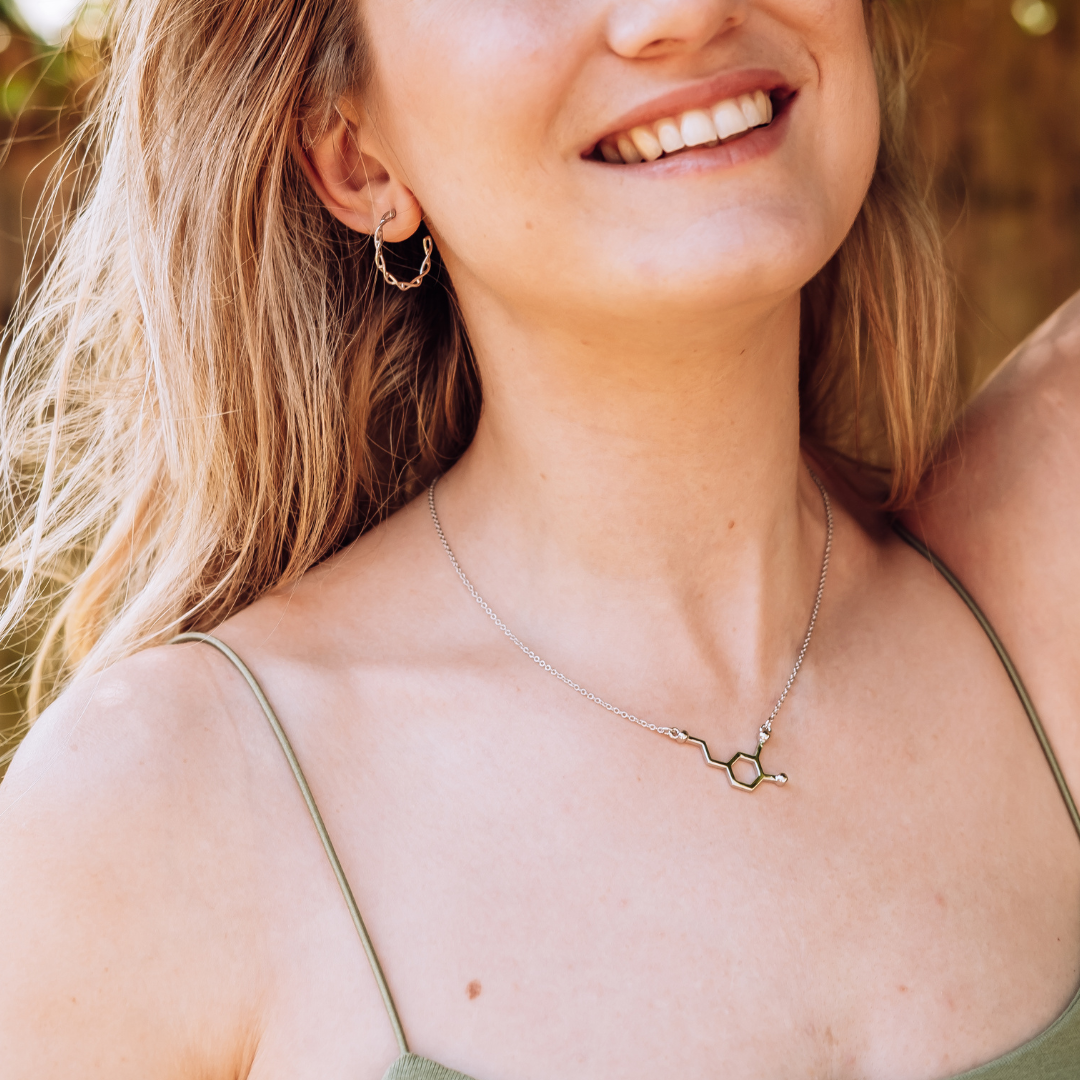 Model wearing dopamine molecule necklace in silver - chemistry inspired jewellery for science lovers | My Chemical Gift