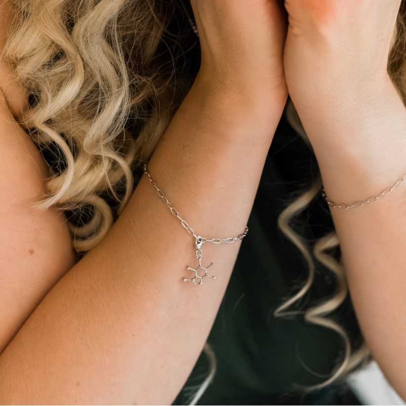 Model wearing caffeine molecule silver charm bracelet - chemistry inspired jewellery for coffee lovers | My Chemical Gift
