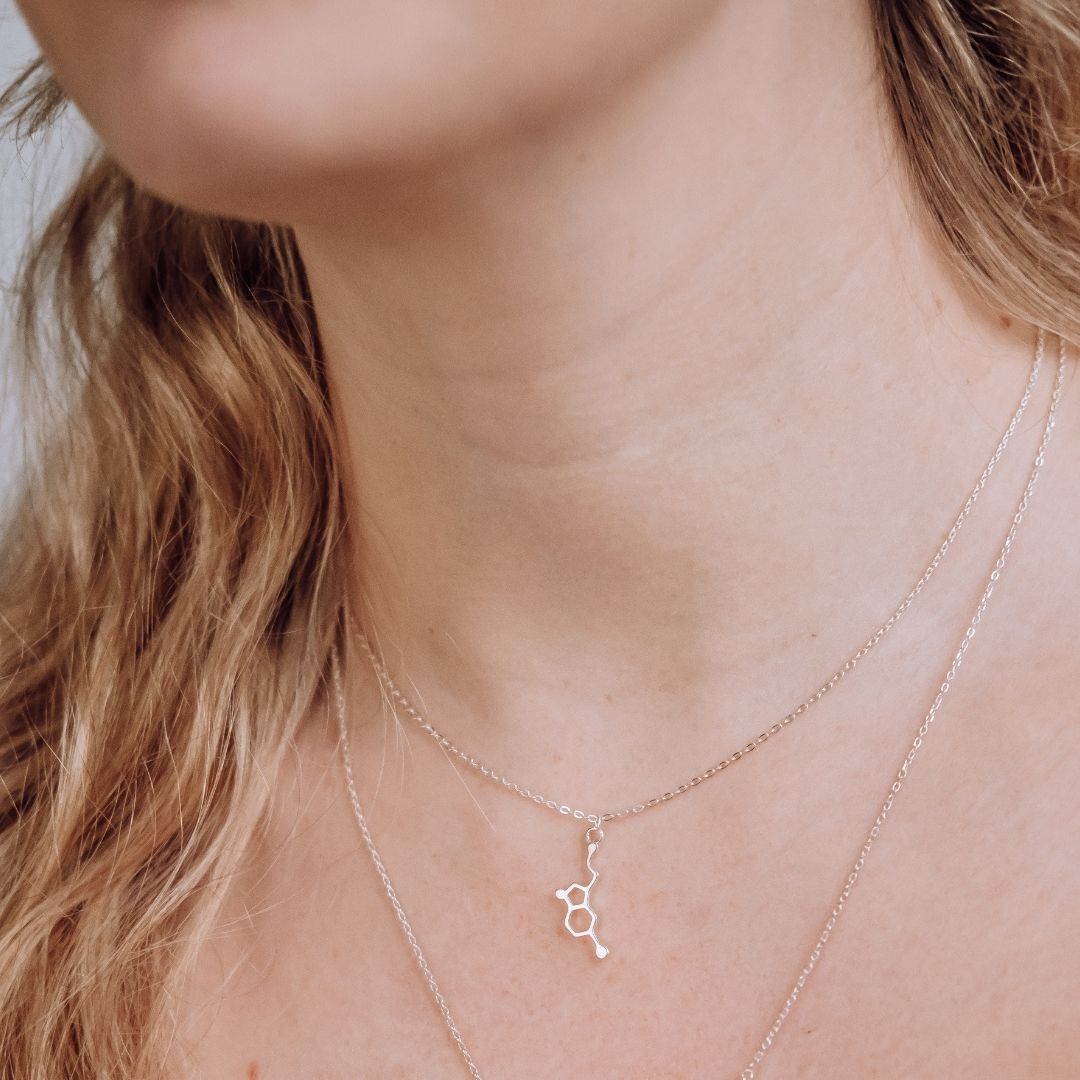 Model wearing serotonin molecule necklace in silver - chemistry inspired jewellery gift for science lovers | My Chemical Gift