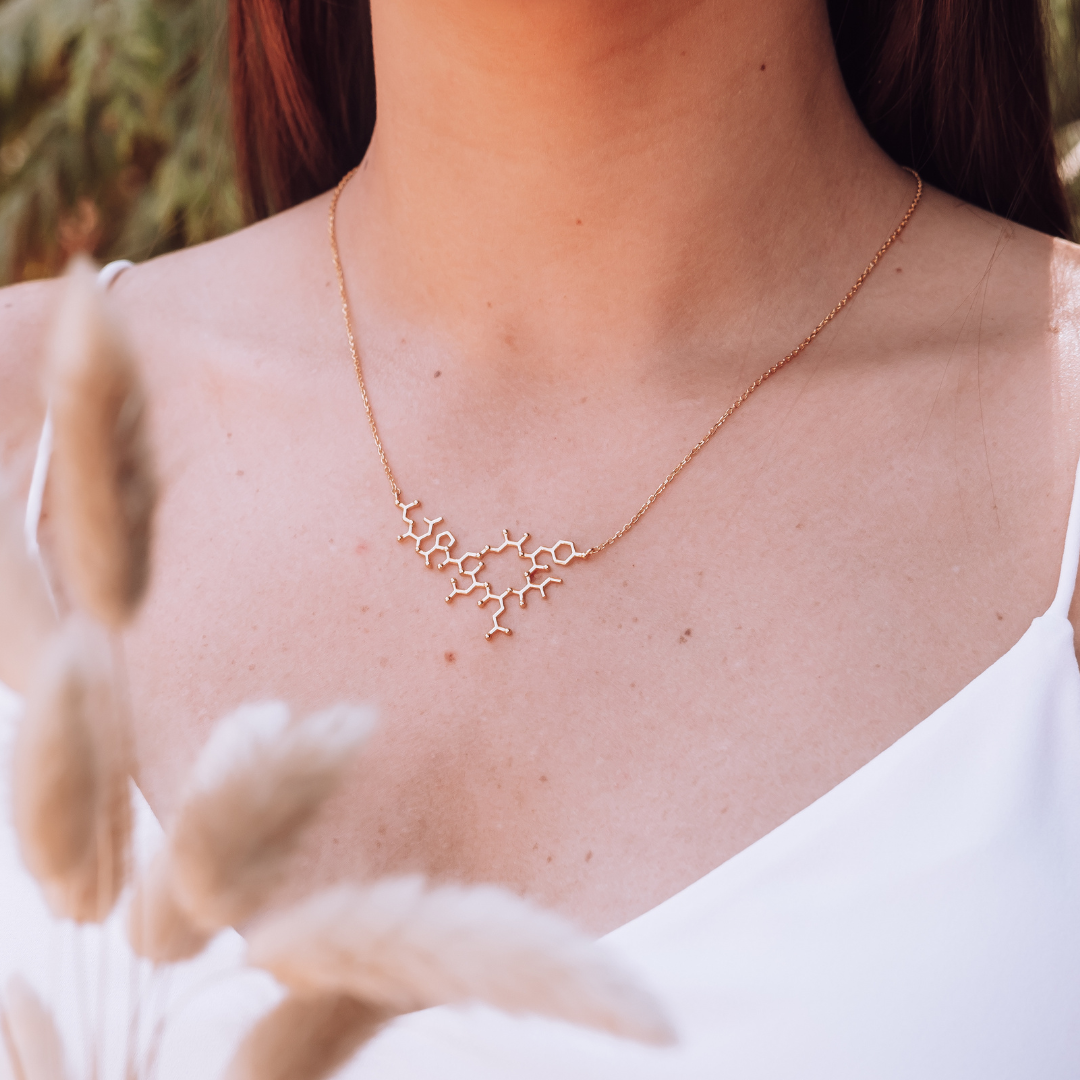 Model wearing oxytocin molecule necklace in gold - love hormone pendant| My Chemical Gift