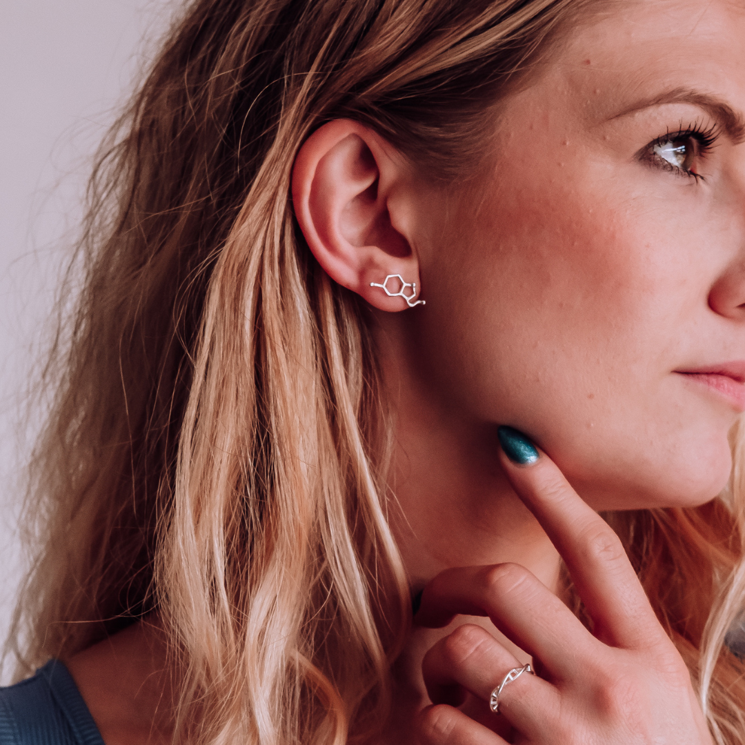 Model wearing serotonin molecule earrings in silver - chemistry inspired jewellery gift for science lovers | My Chemical Gift