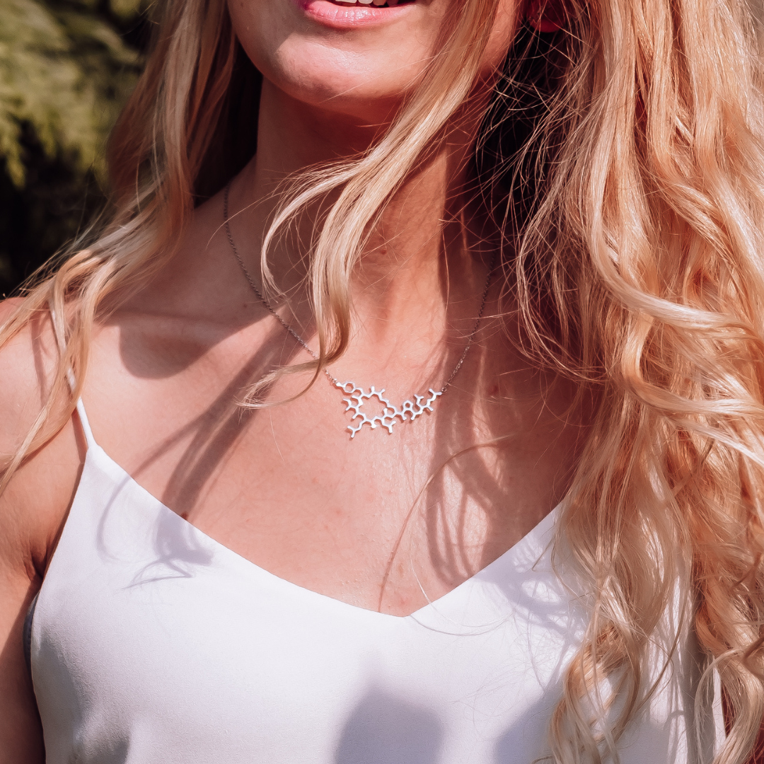 Model wearing oxytocin molecule necklace in silver - love hormone pendant | My Chemical Gift