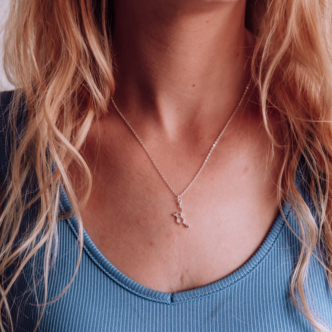Model wearing serotonin molecule necklace in silver - chemistry inspired jewellery gift for science lovers | My Chemical Gift