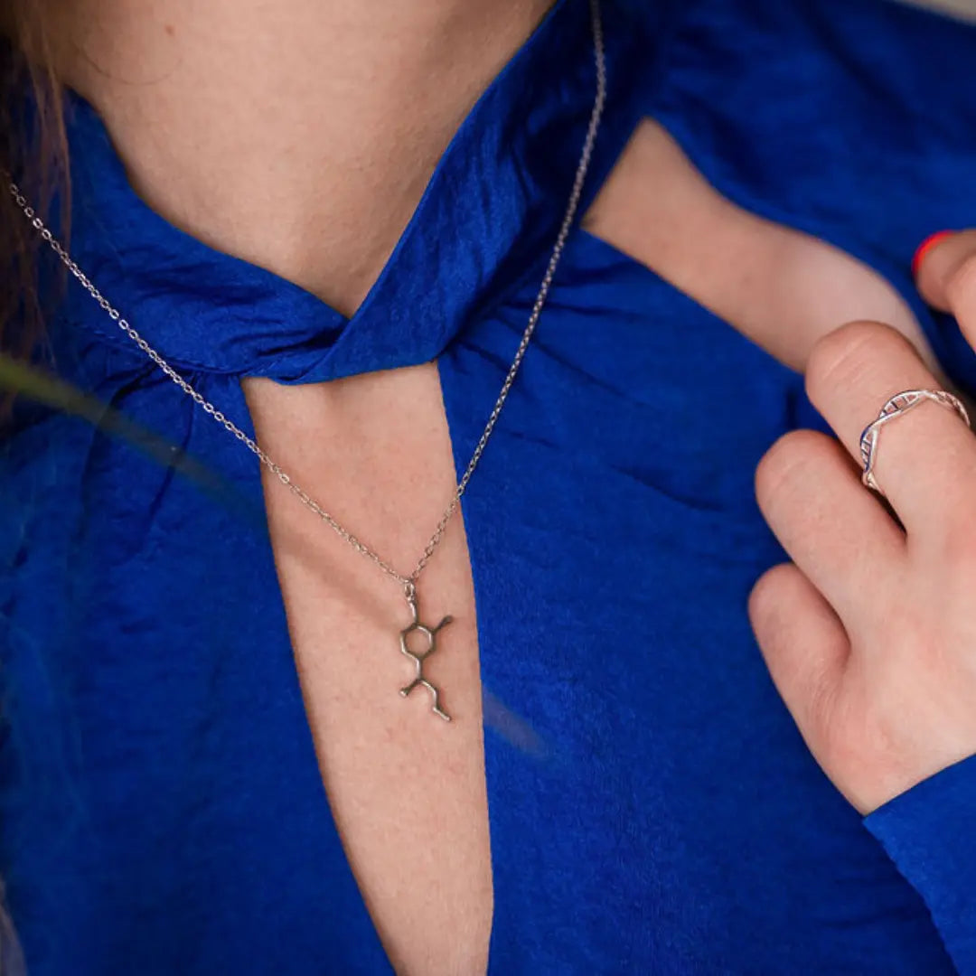 Model wearing adrenaline molecule necklace in silver - chemistry inspired jewellery gift for science lovers 