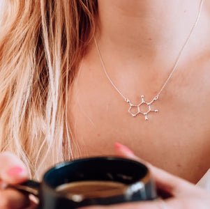 Model wearing caffeine molecule necklace in silver - chemistry inspired jewellery gift for coffee lovers 