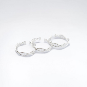 silver DNA helix ring on white background