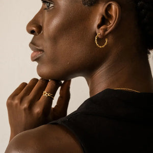 Model wearing DNA double helix hoop earrings and serotonin molecule ring in gold - chemistry inspired jewellery for science lovers | My Chemical Gift