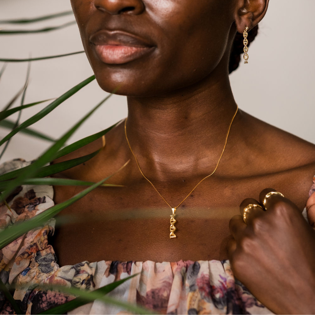 Model wearing DNA double helix necklace in gold - chemistry inspired jewellery gift for science lovers | My Chemical Gift