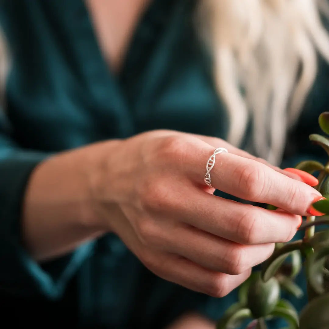 Model wearing DNA double helix ring in silver - chemistry inspired jewellery gift for science lovers 