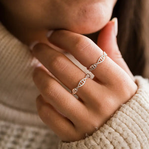 Model wearing DNA double helix ring in silver - chemistry inspired jewellery gift for science lovers 