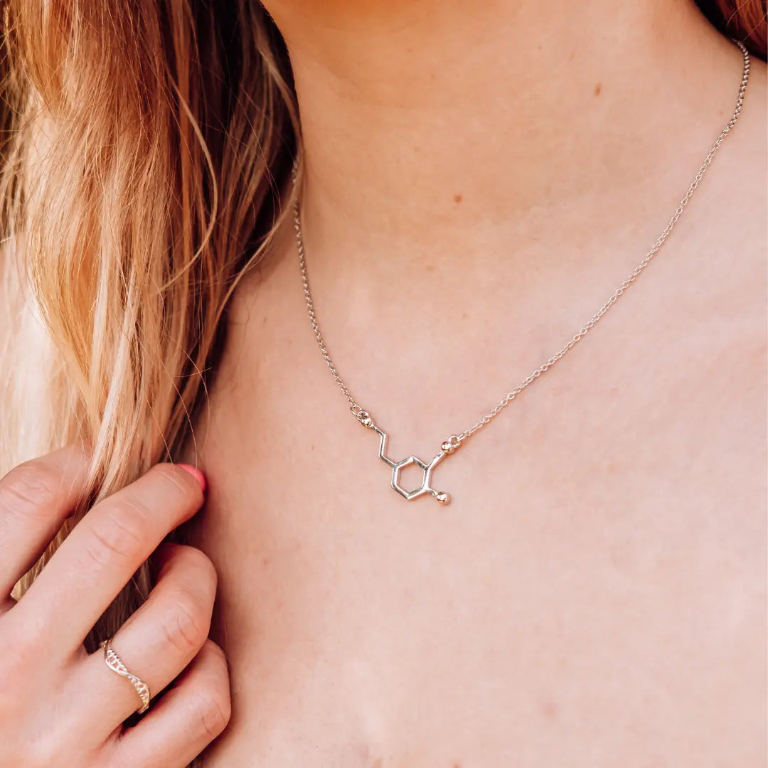 Model wearing dopamine molecule necklace in silver - chemistry inspired jewellery for science lovers 