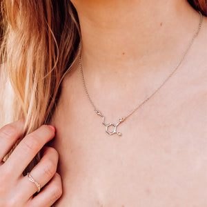 Model wearing dopamine molecule necklace in silver - chemistry inspired jewellery for science lovers 