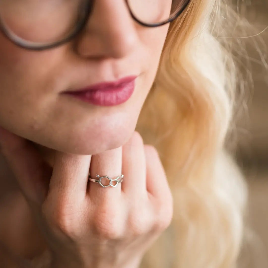 Model wearing serotonin molecule ring in silver - chemistry inspired jewellery for science lovers 