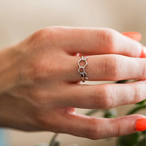 Model wearing serotonin molecule ring in silver - chemistry inspired jewellery for science lovers 