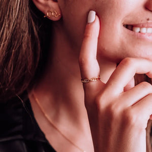 Model wearing DNA double helix ring in gold - chemistry inspired jewellery gift for science lovers 