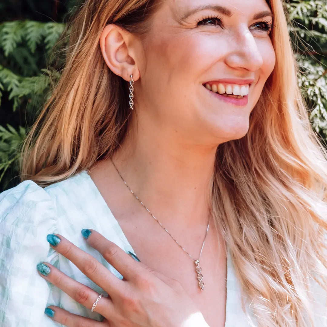 Model wearing DNA double helix necklace and earrings in silver - chemistry inspired jewellery gift for science lovers 