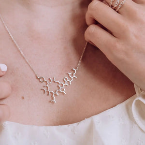 Model wearing oxytocin molecule necklace in silver - love hormone pendant 