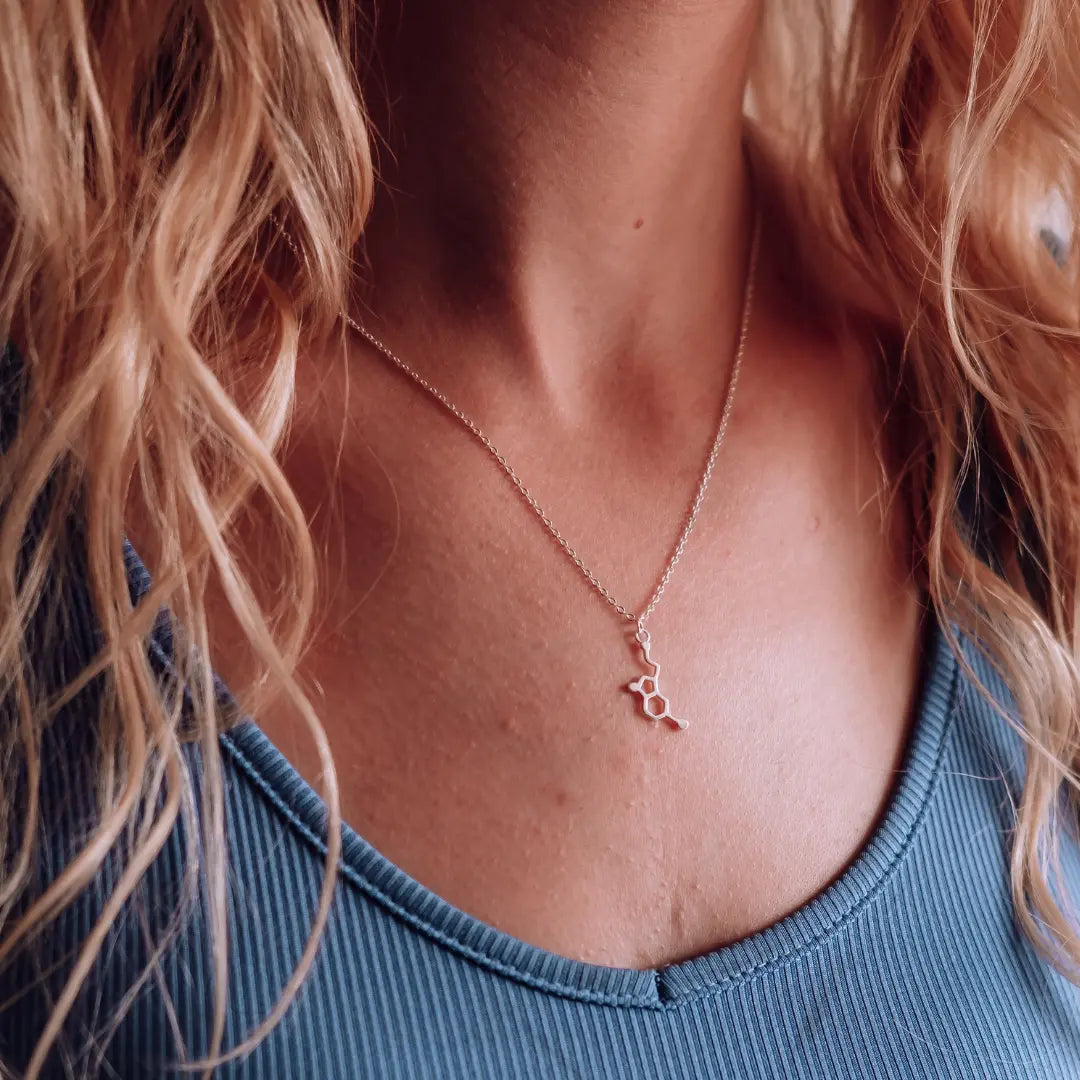Model wearing serotonin molecule necklace in silver - chemistry inspired jewellery gift for science lovers 