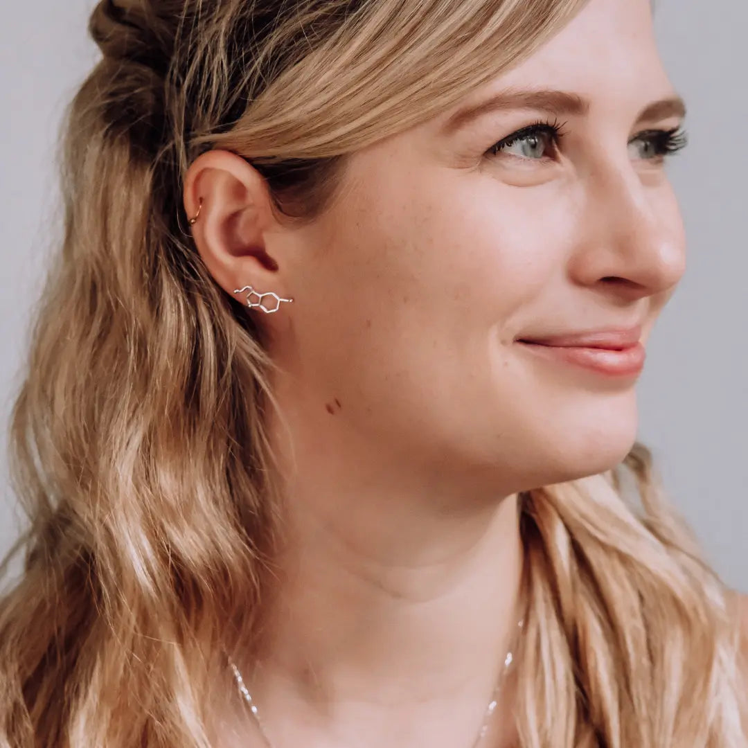 Model wearing serotonin molecule earrings in silver - chemistry inspired jewellery gift for science lovers 