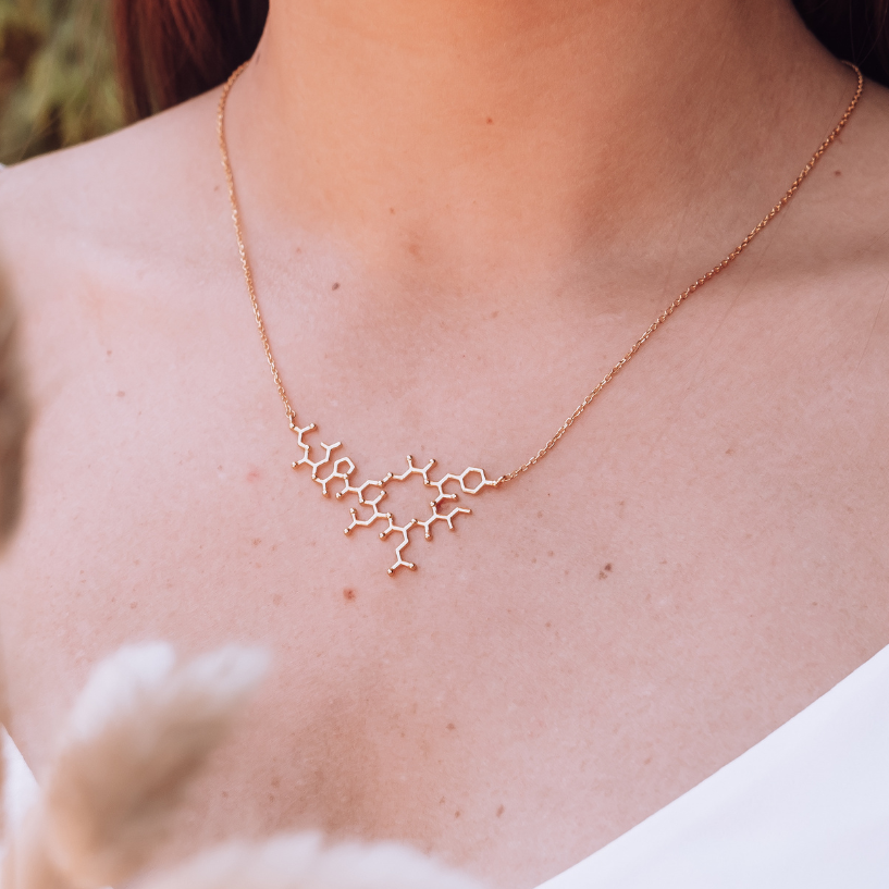 Model wearing oxytocin molecule necklace in gold - love hormone pendant| My Chemical Gift