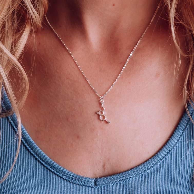 Model wearing serotonin molecule necklace in silver - chemistry inspired jewellery gift for science lovers | My Chemical Gift