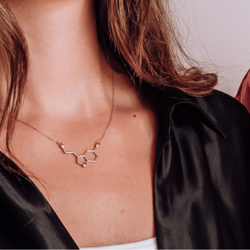 Model wearing serotonin molecule necklace in silver - chemistry inspired jewellery gift for science lovers | My Chemical Gift