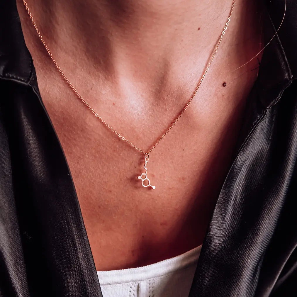 Model wearing serotonin molecule necklace in gold - chemistry inspired jewellery gift for science lovers 