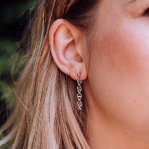 Model wearing DNA double helix earrings in silver - chemistry inspired jewellery gift for science lovers | My Chemical Gift